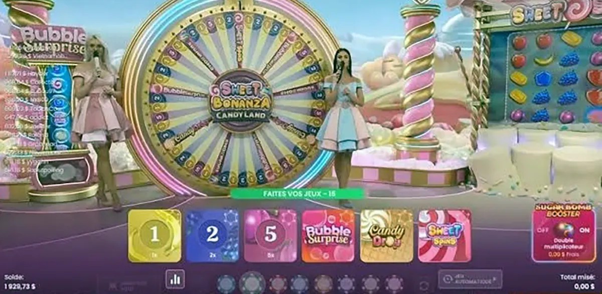 “Two live presenters stand beside a large illuminated bonus wheel on the Sweet Bonanza CandyLand game show set, with candy-themed columns, pastel scenery, and betting options displayed on the screen.”